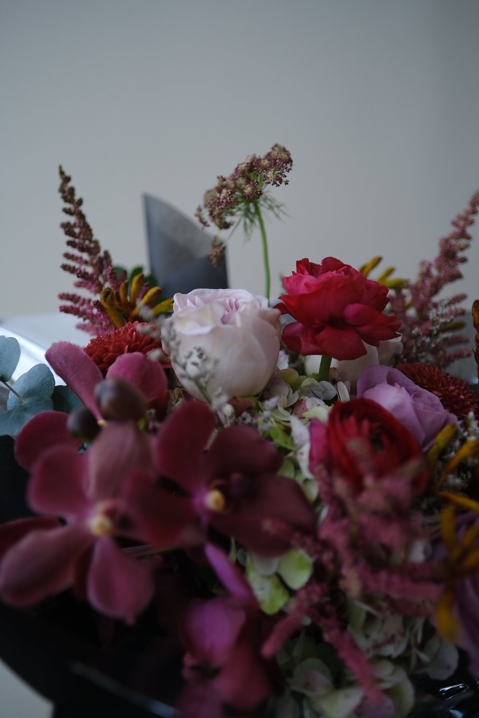Bold Expressive Bouquet with Orchids Ranunculous Dark Red Filler Flowers