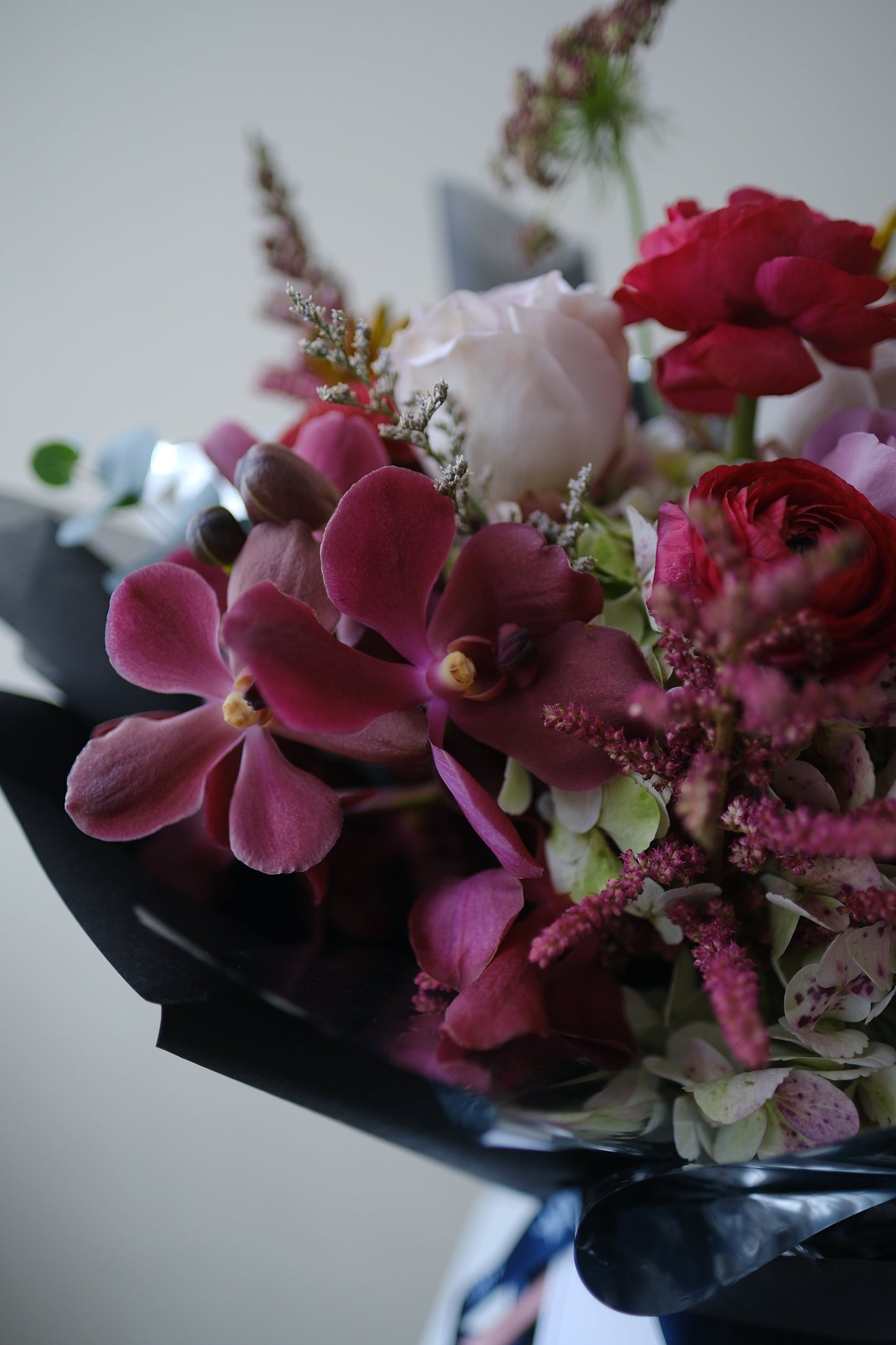 Bold Expressive Bouquet with Orchids Ranunculous Dark Red Filler Flowers