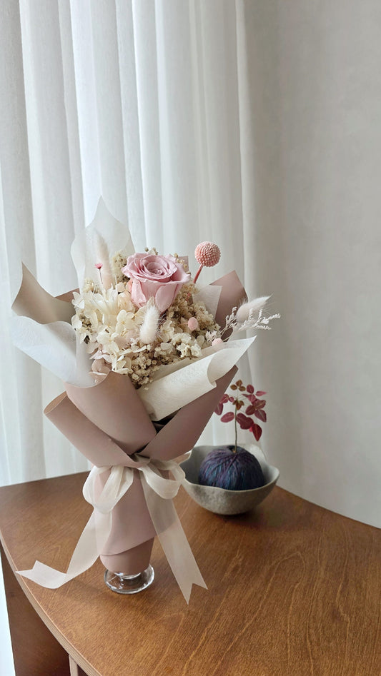 Single blush everlasting rose posy with preserved flowers in neutral wrapping