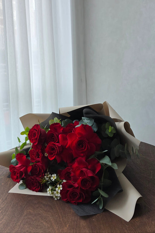 Crimson Devotion red rose bouquet with eucalyptus, wrapped in neutral tones