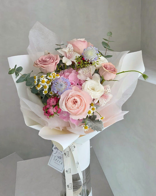 Pastel hydrangea and rose bouquet in a soft garden-style floral arrangement