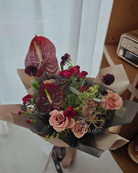 Sculptural omakase bouquet with anthuriums, dark roses, and seasonal berries — bold statement arrangement by Flowers by Terra Singapore