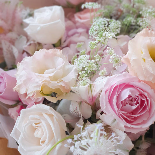Close-up of pastel roses and eustoma with ammi majus and didiscus blue lace — seasonal flowers in Terra's Choice Soft & Pastels omakase bouquet