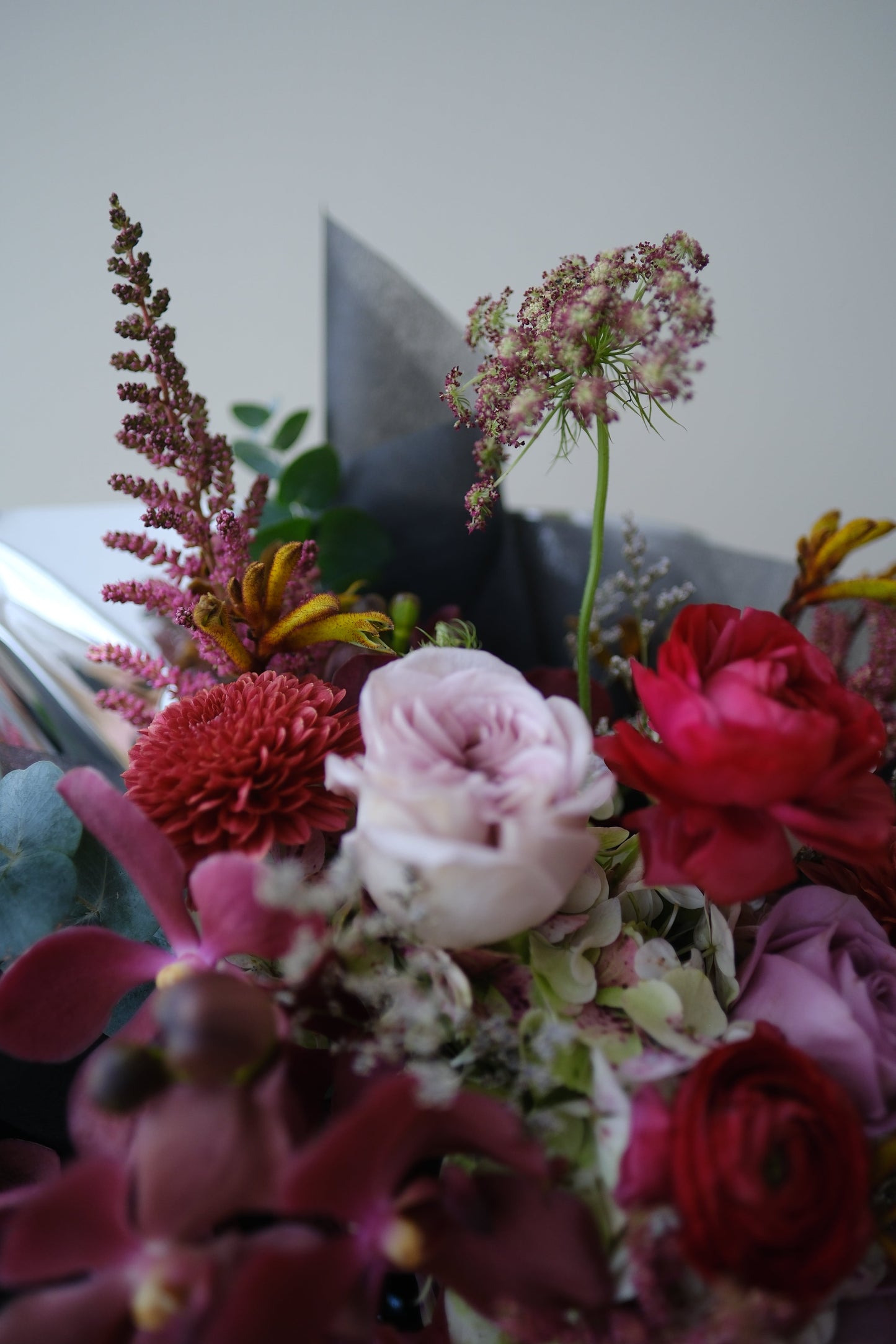 Bold Expressive Bouquet with Orchids Ranunculous Dark Red Filler Flowers