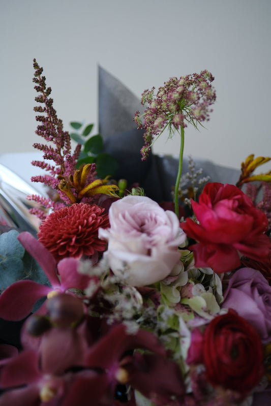 Bold Expressive Bouquet with Orchids Ranunculous Dark Red Filler Flowers