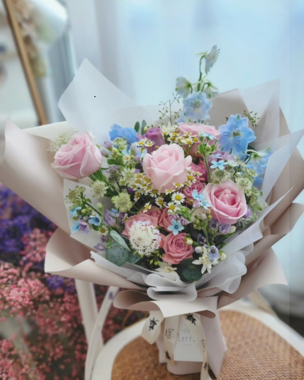 Blush and light blue bouquet with roses, daisies and delphiniums 