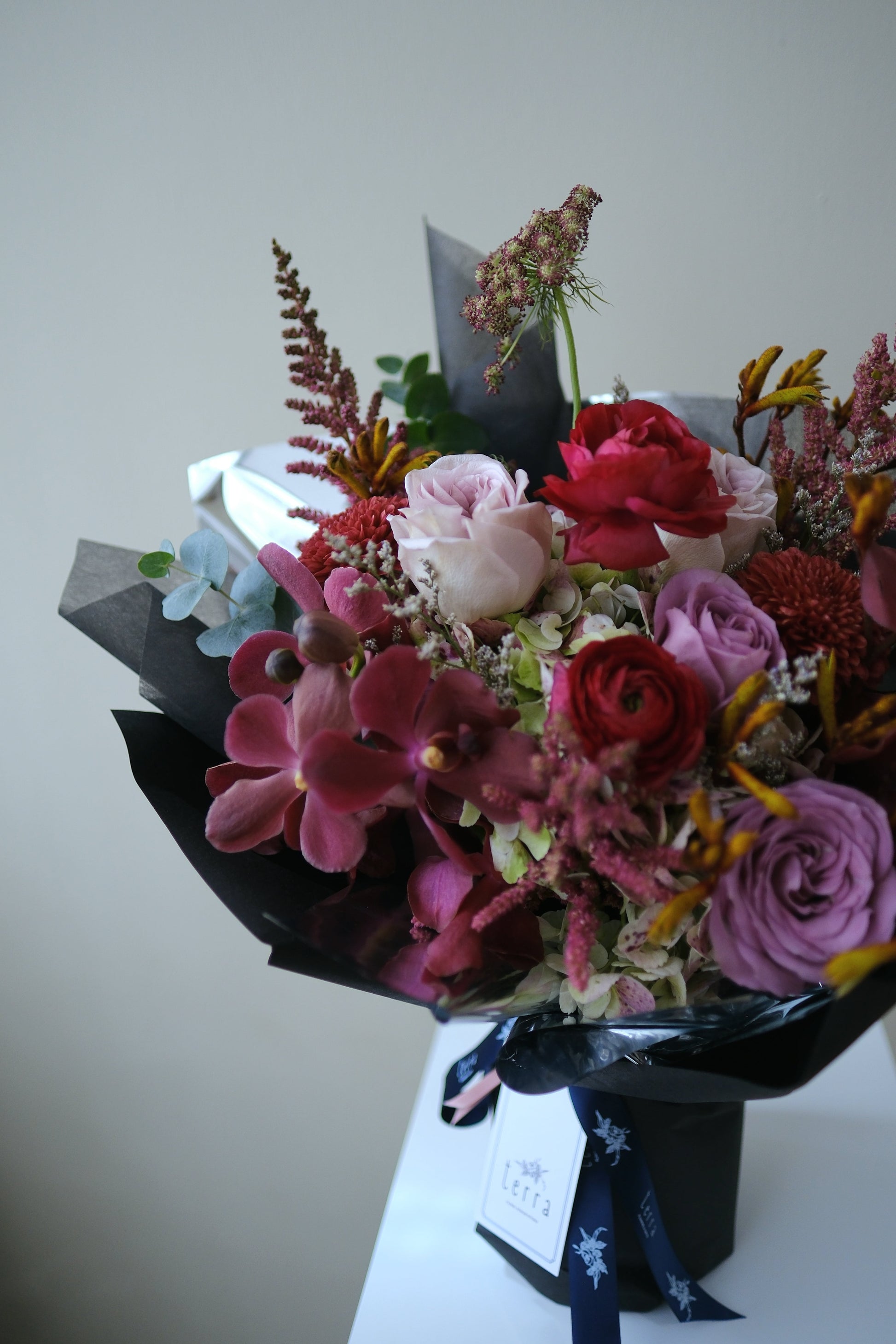 Bold Expressive Bouquet with Orchids Ranunculous Dark Red Filler Flowers