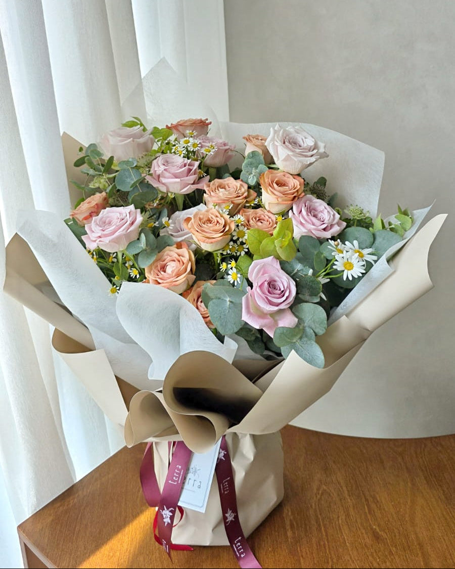 Soft blush and cappuccino roses bouquet by window light, aesthetic flower delivery Singapore