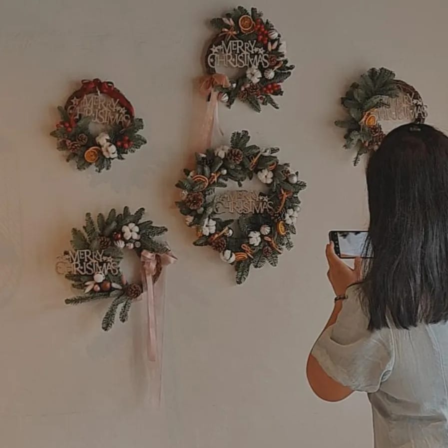Christmas Wreath Workshop Participant taking photo of the end products