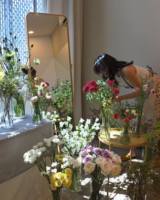 Mother's Day Spring Jar Arrangement Workshop - Participant picking flowers from a curated flower bar