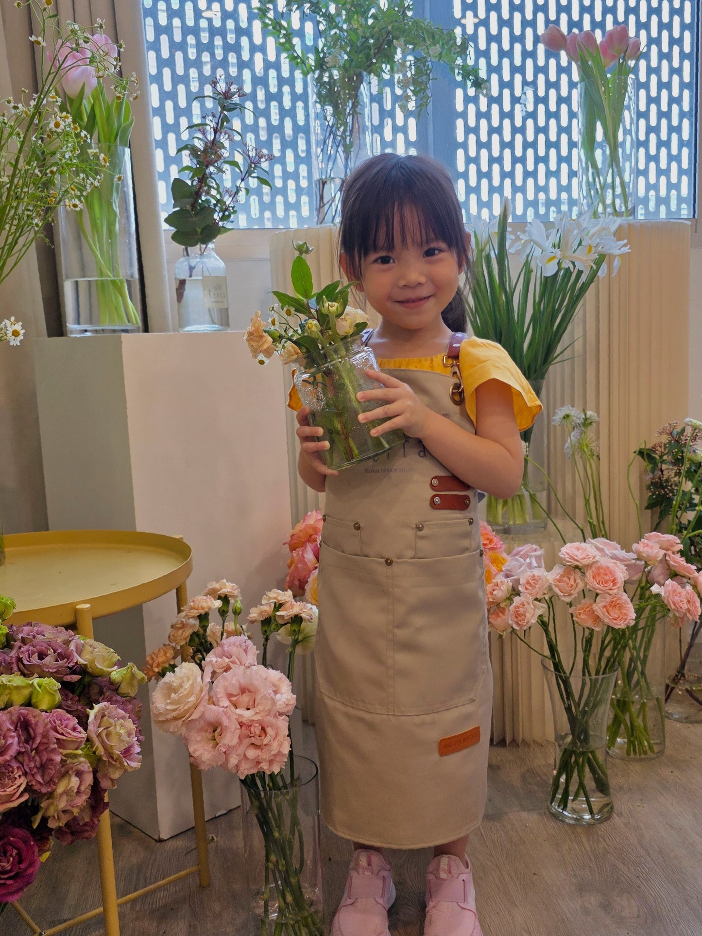 Mother's Day Spring Jar Arrangement Workshop - Young girl holding a jar of flowers 