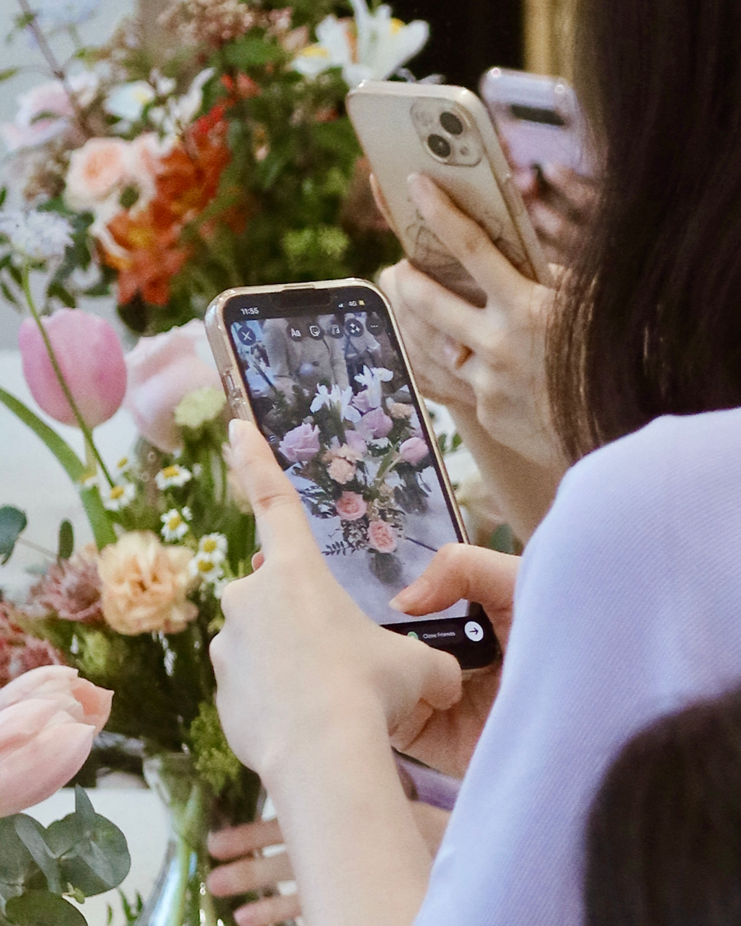 Mother's Day Spring Jar Arrangement Workshop - Participant using phone to capture their works