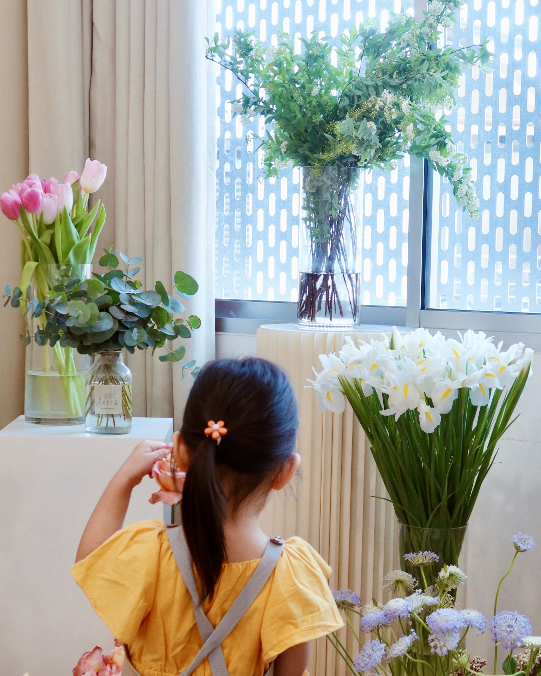 Mother's Day Spring Jar Arrangement Workshop - Backview of young girl picking out flowers