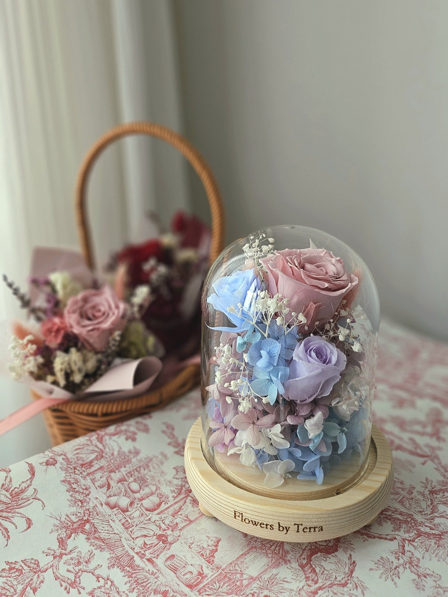 Preserved Roses and Hydrangeas in Pastel colours in a glass dome with a wooden base