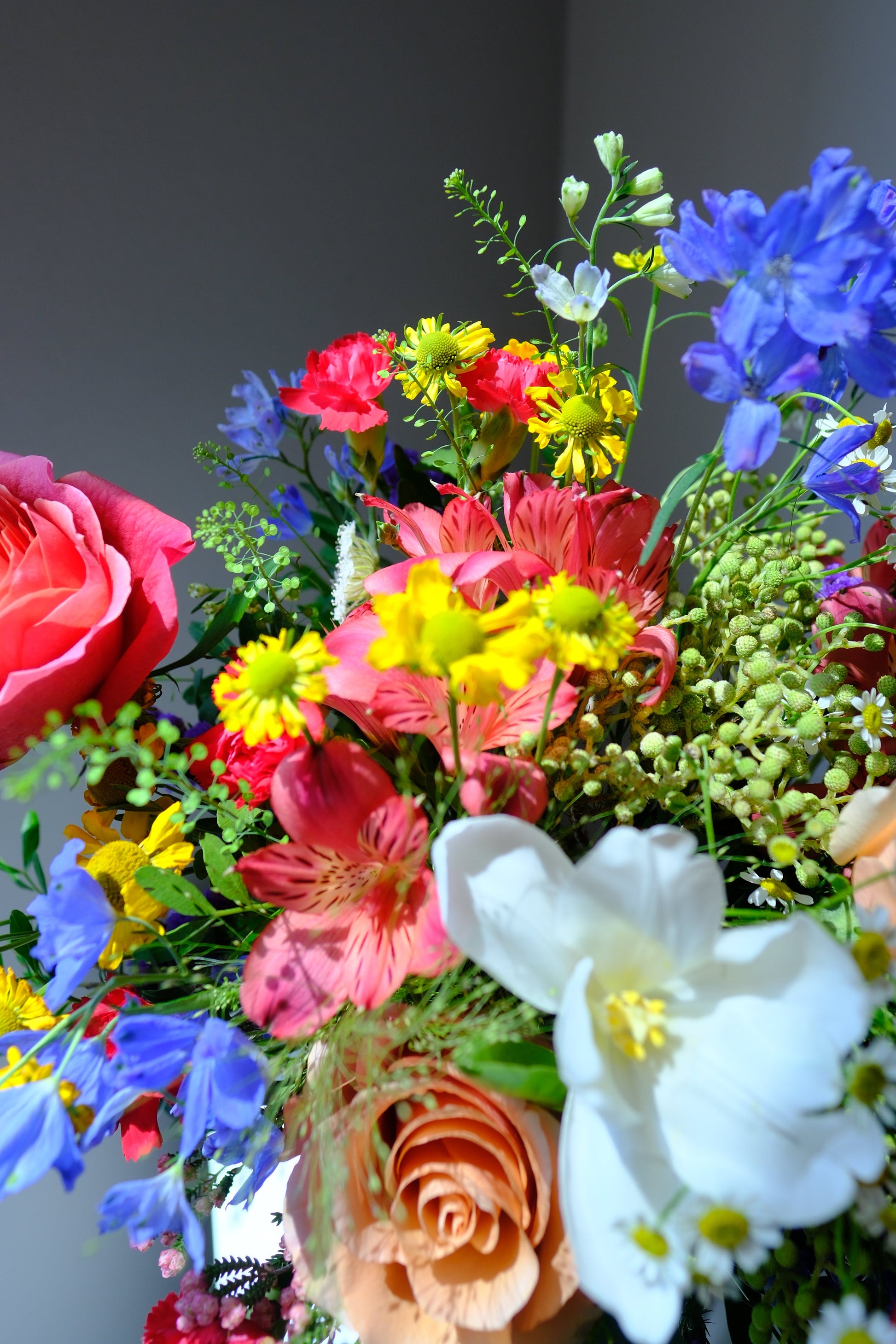 Bright and Joyful Designer's Choice a Colorful garden bouquet of flowers such as tulips garden roses alstroemerias and mini delphiniums