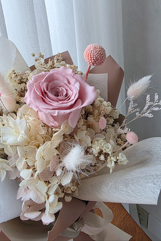 Single blush everlasting rose posy with preserved flowers in neutral wrapping