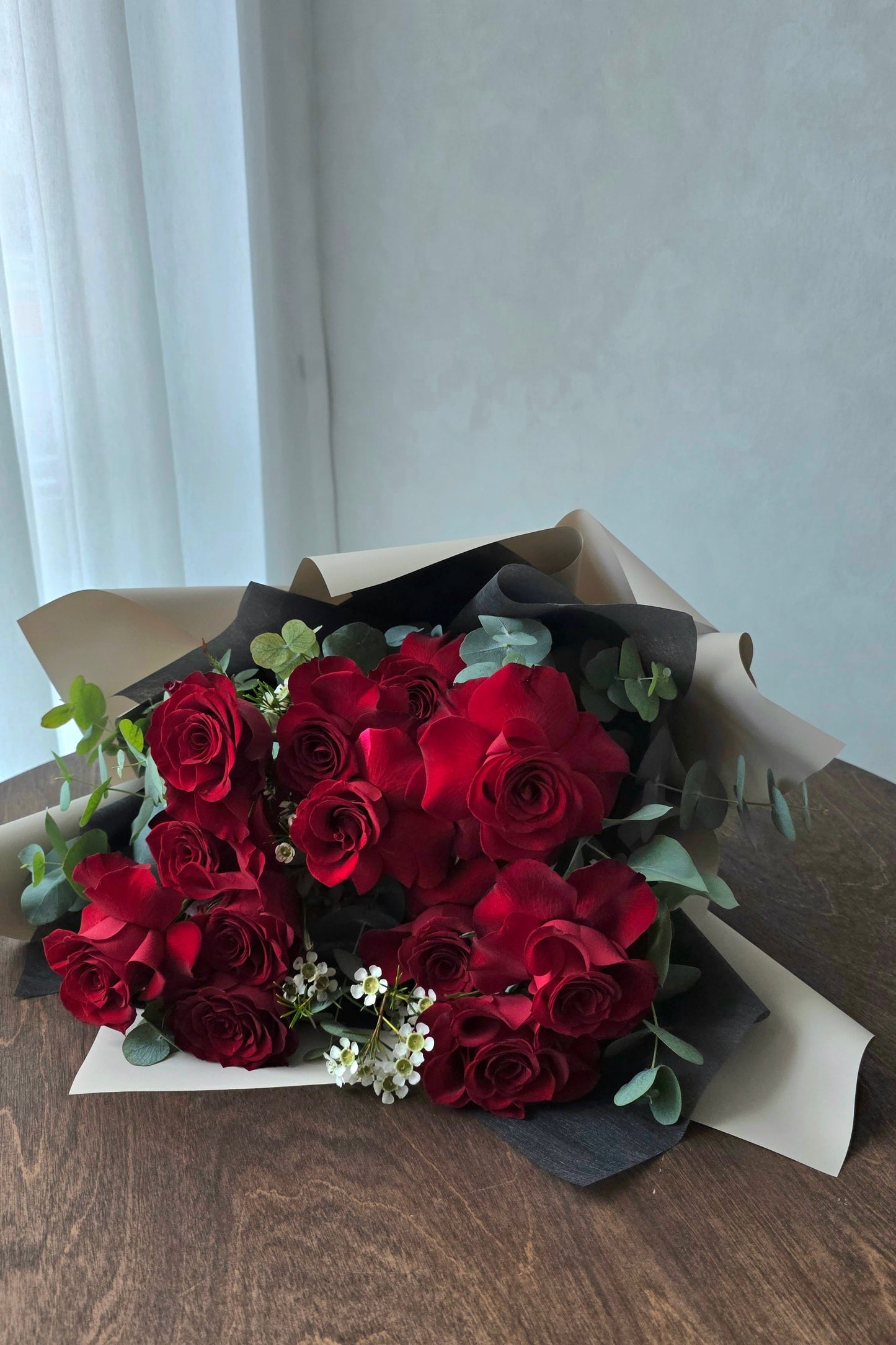 Side view of classic red rose bouquet by Flowers by Terra