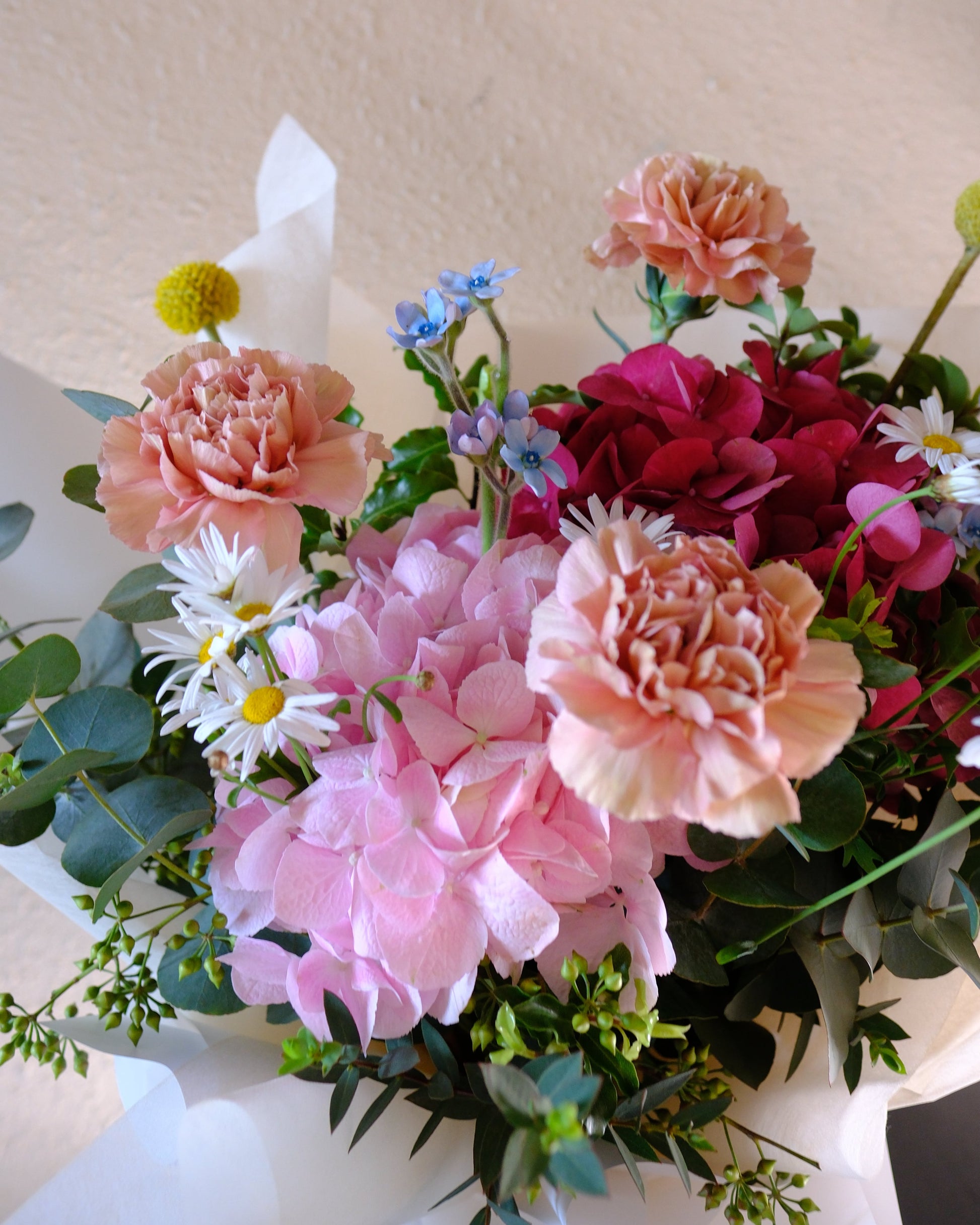 Side profile of the In Full Swing Mother's Day bouquet showing arrangement depth and volume — Dutch carnations and seasonal blooms, Flowers by Terra Singapore