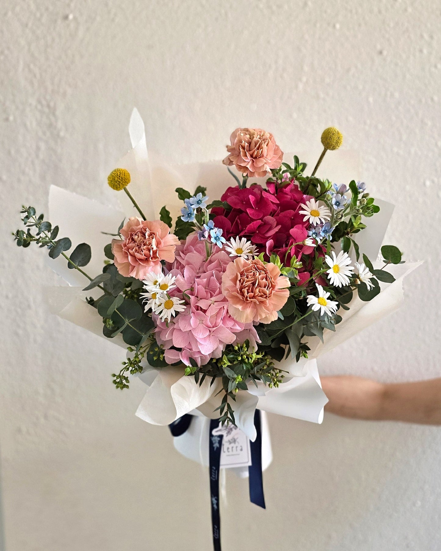 In Full Swing vibrant Mother's Day bouquet — full view of dusty pink carnations, hydrangeas, Margarite daisies, and billy buttons by Flowers by Terra Singapore