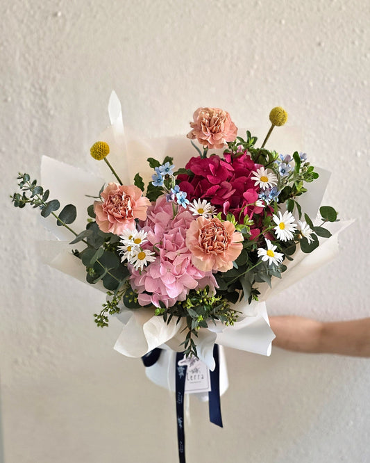 In Full Swing vibrant Mother's Day bouquet — full view of dusty pink carnations, hydrangeas, Margarite daisies, and billy buttons by Flowers by Terra Singapore