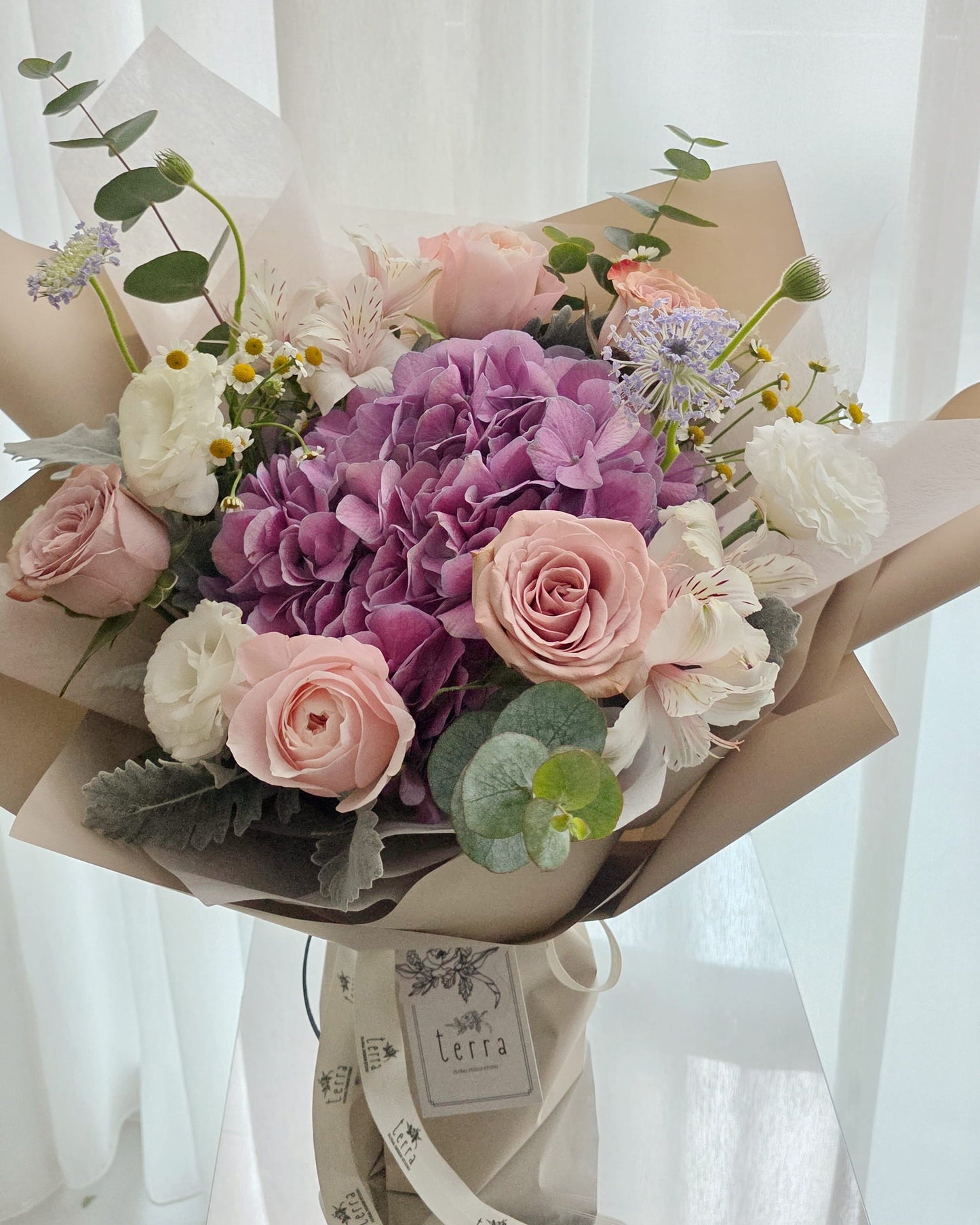 Close-up of hydrangea and garden roses in a soft romantic bouquet