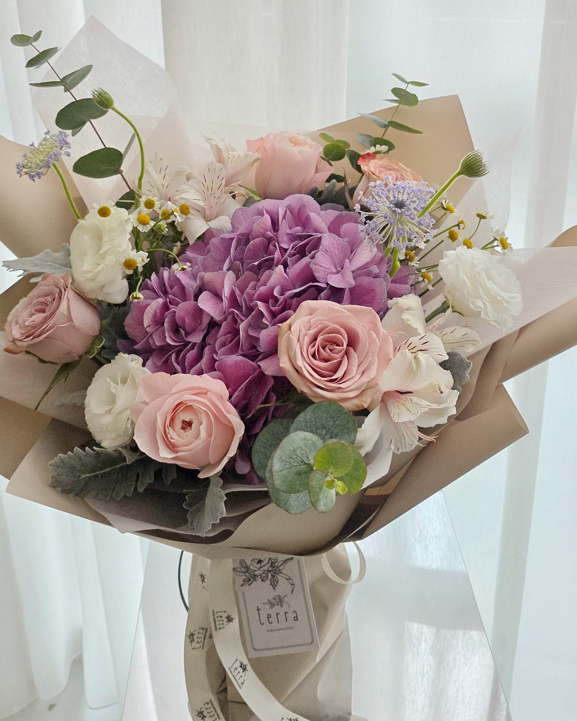 Close-up of hydrangea and garden roses in a soft romantic bouquet