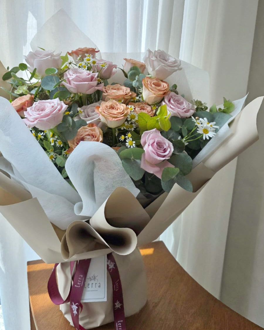 Soft blush and cappuccino roses bouquet by window light, aesthetic flower delivery Singapore