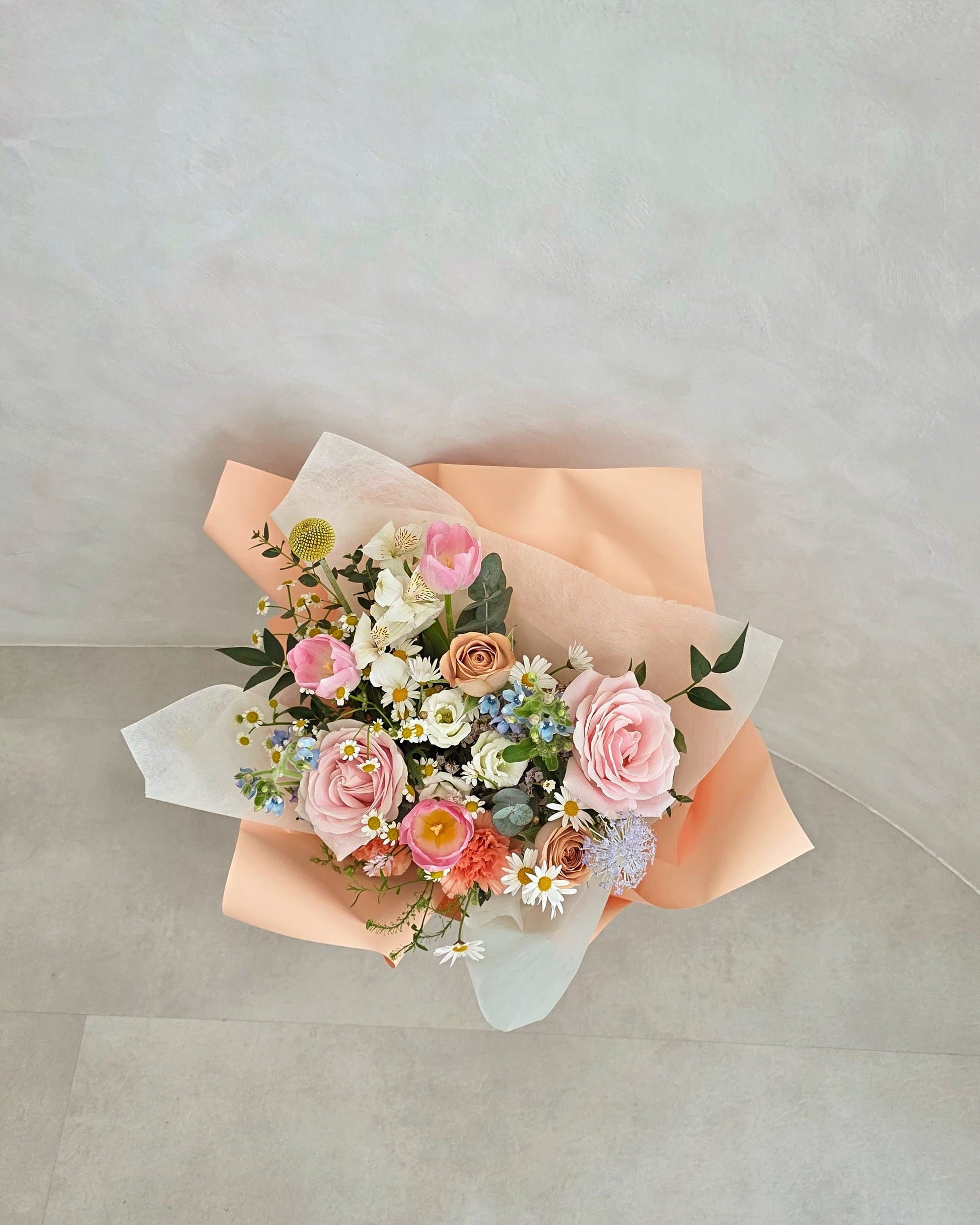Flowers by Terra Her Garden Mother's Day bouquet 2026 — full lush arrangement of pink roses, blush tulips and wildflowers in elegant peach wrap, Singapore florist