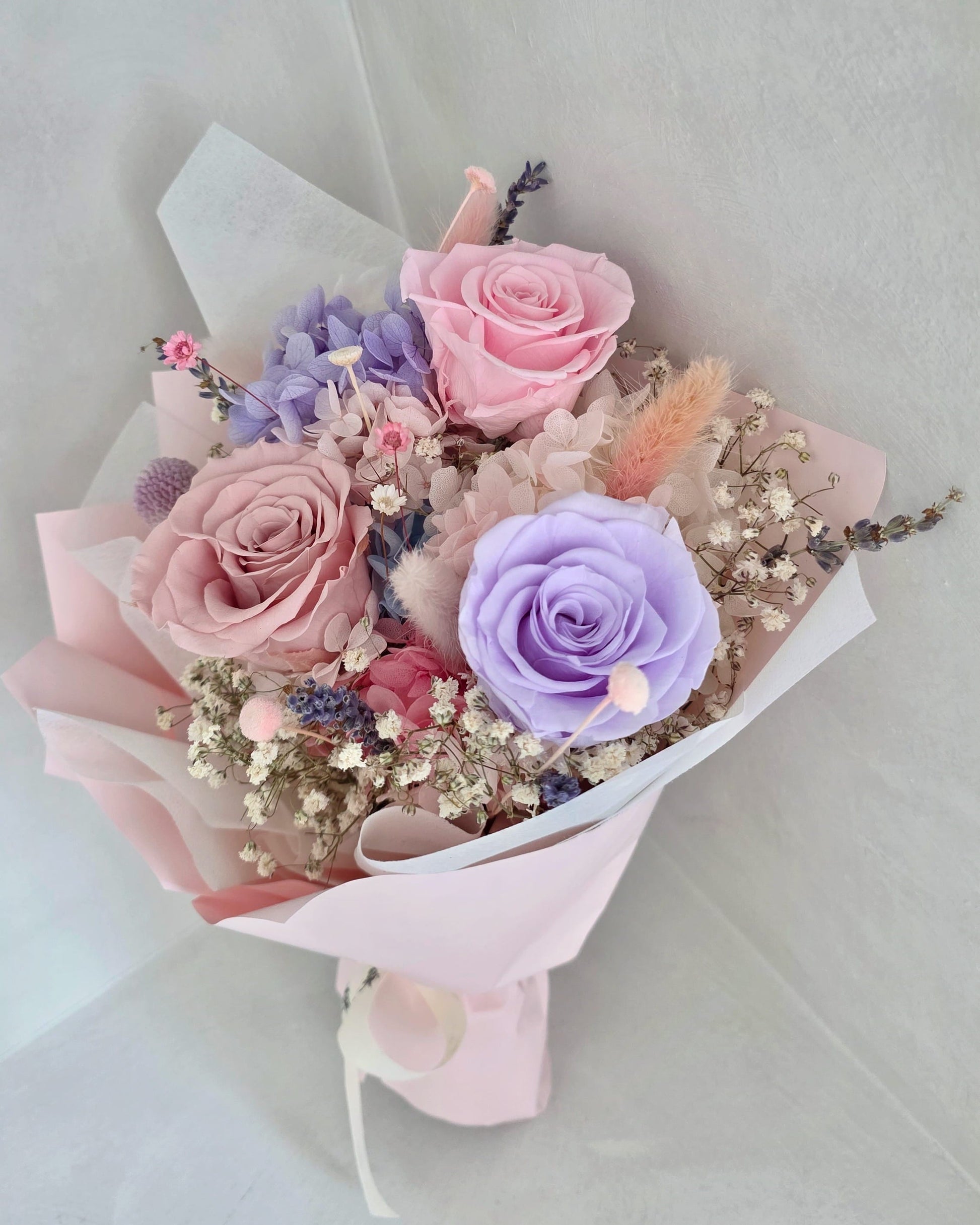 Close up of preserved roses and hydrangea in pastel everlasting bouquet