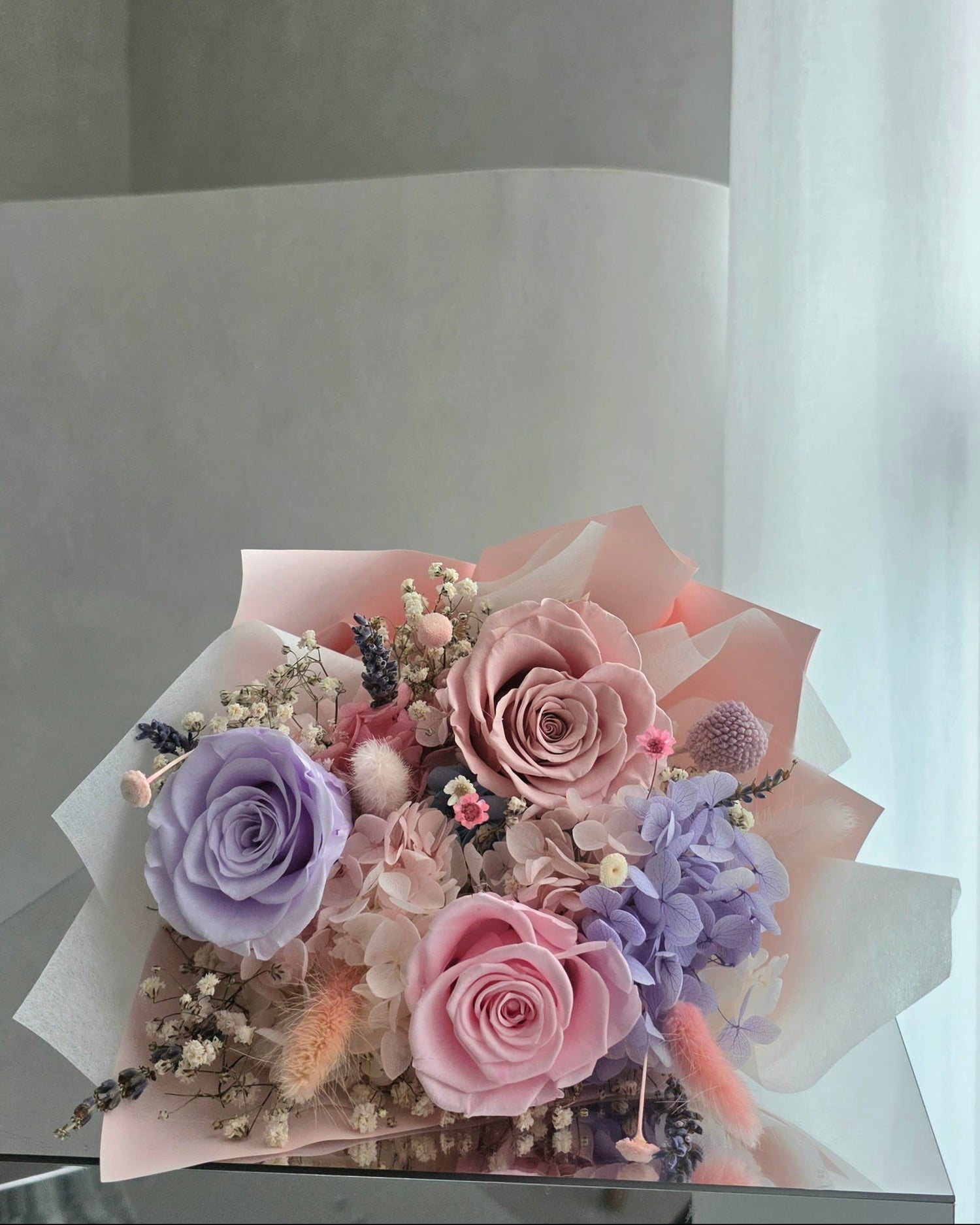 Pastel everlasting rose bouquet with preserved roses and hydrangea in soft pink and lilac tones