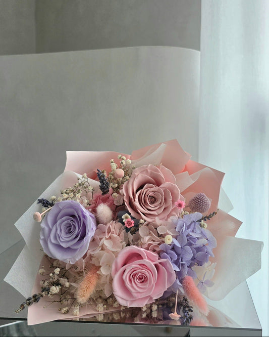 Pastel everlasting rose bouquet with preserved roses and hydrangea in soft pink and lilac tones