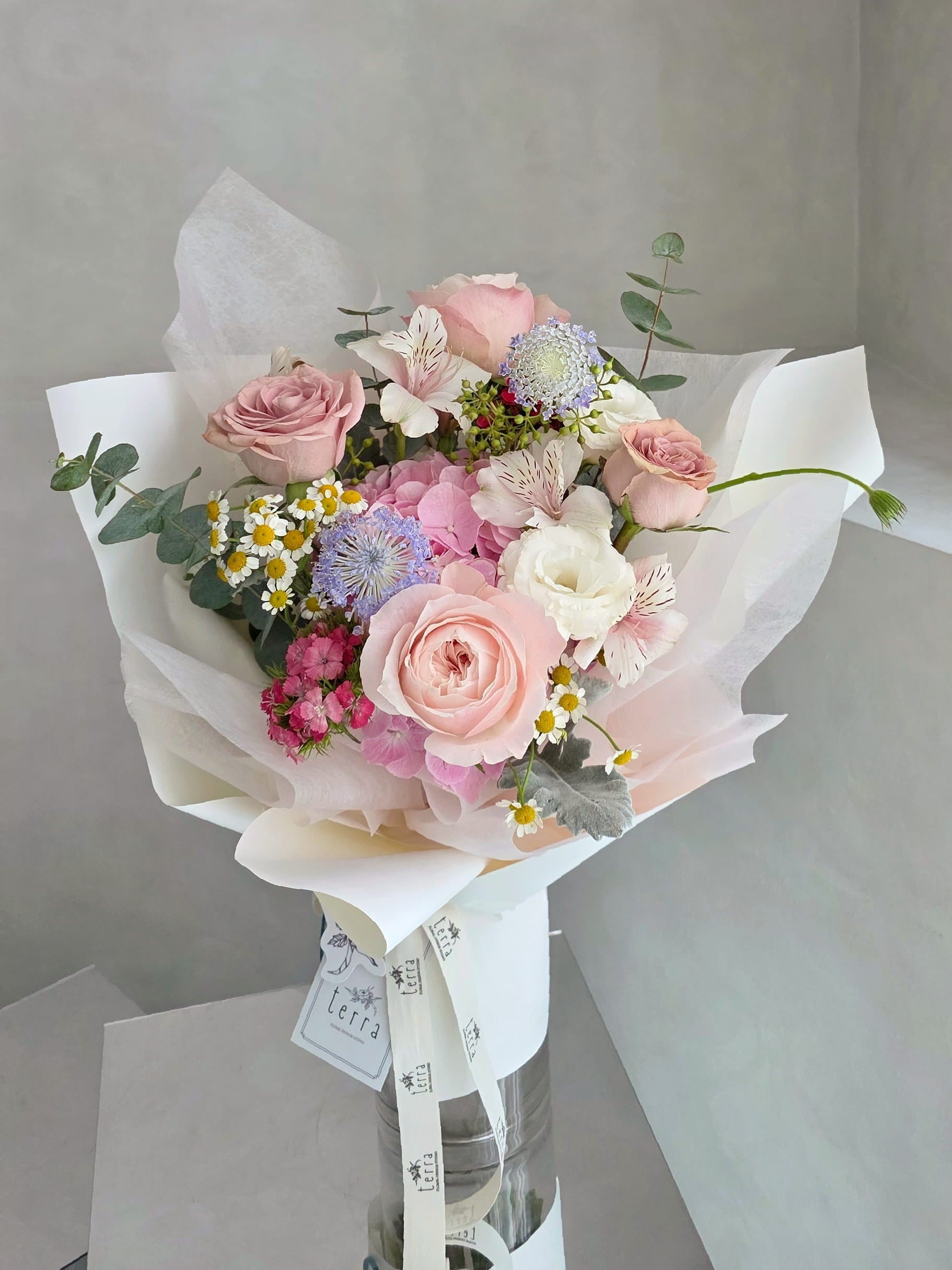 Pastel hydrangea and rose bouquet in a soft garden-style floral arrangement