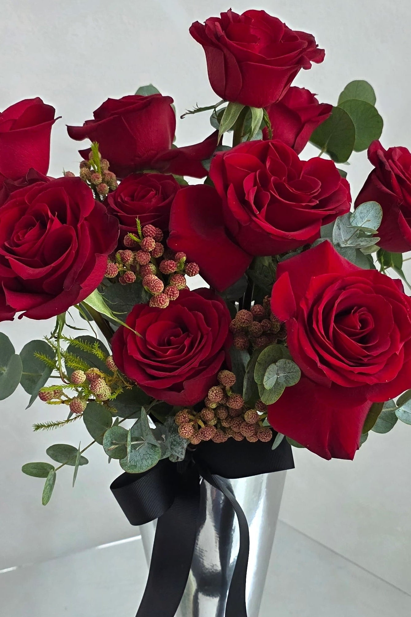 Close-up of premium red roses in a modern Valentine’s Day vase arrangement