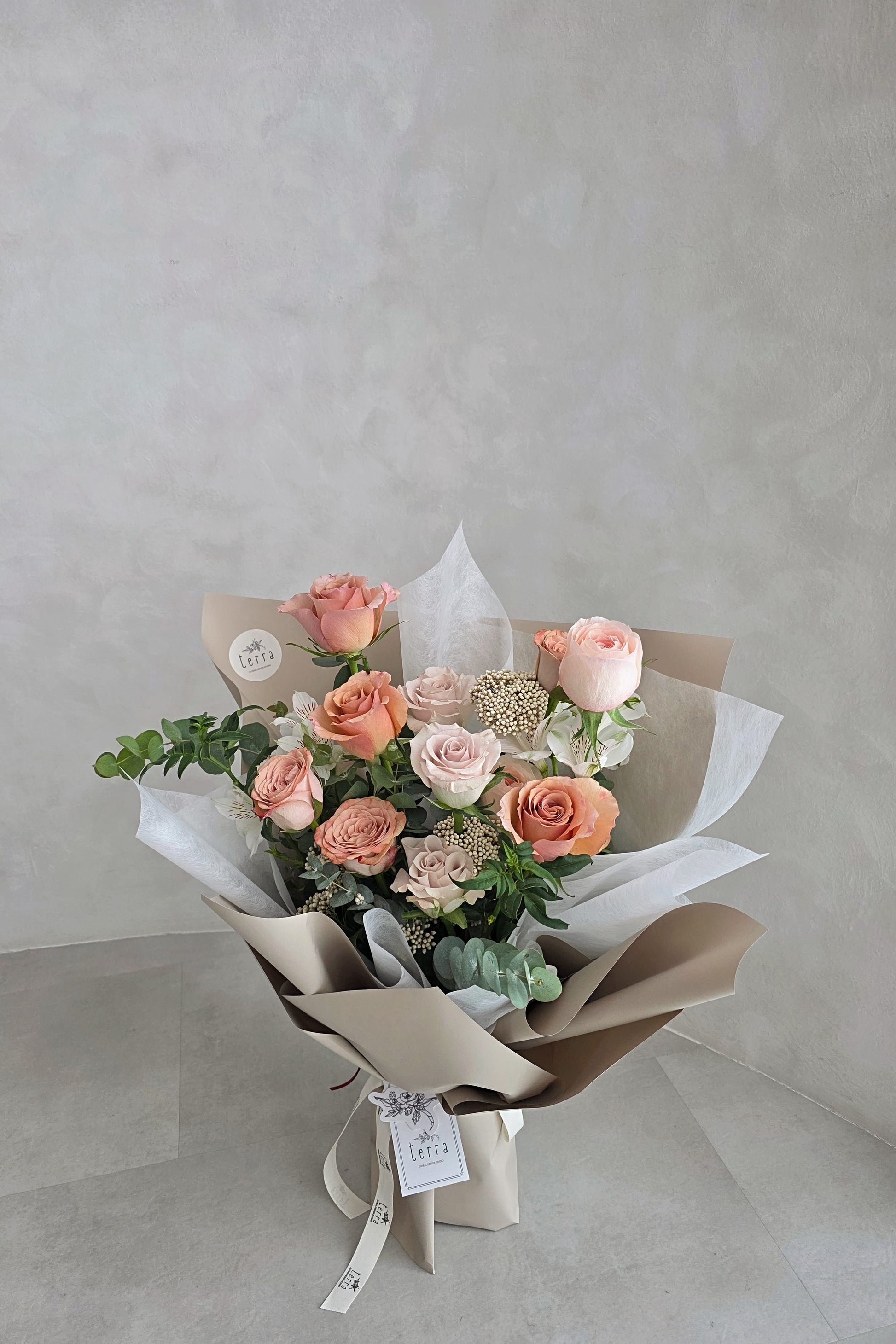 Antique Rose Bouquet Flowers by Terra — full bouquet with sand kraft wrap on floor, showing scale and volume