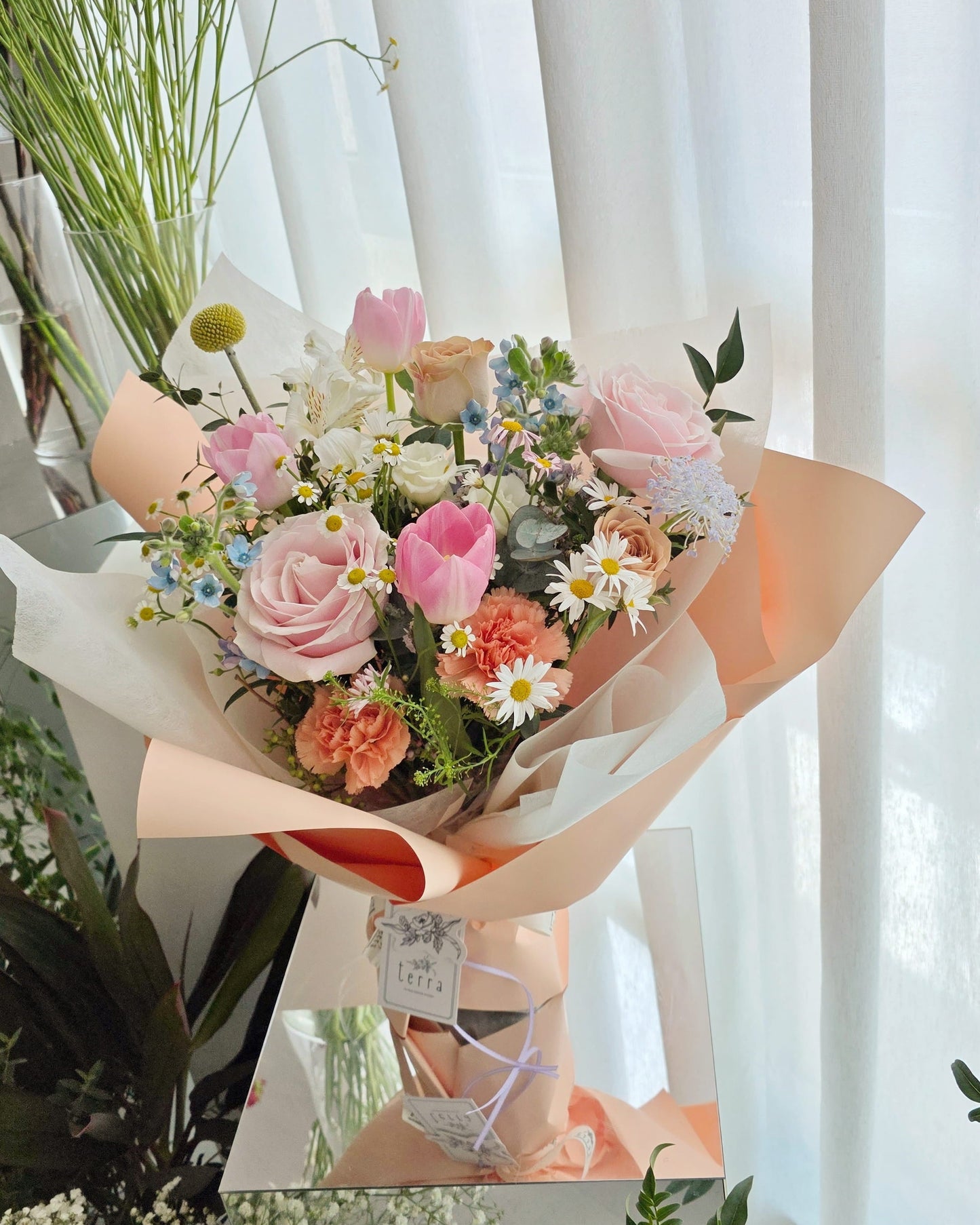 Her Garden by Flowers by Terra — Mother's Day bouquet with pink roses, blush tulips and champagne garden roses in layered peach and cream paper wrapping