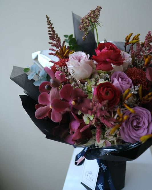 Bold and textural omakase bouquet with dark red orchids, ranunculus, and moody filler flowers — Singapore flower delivery by Flowers by Terra