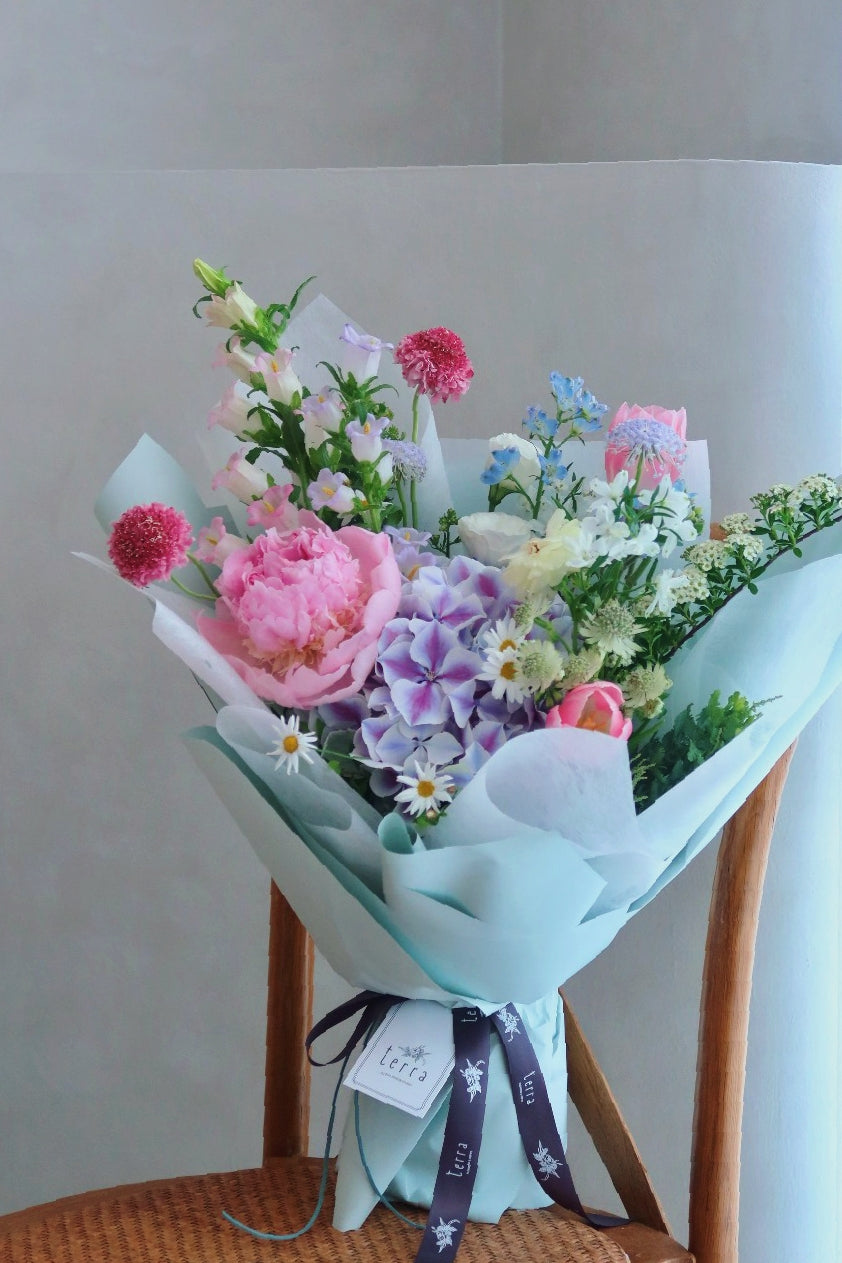 Soft and pastel omakase bouquet in a vase arrangement — lifestyle shot showing the Terra's Choice Soft & Pastels in a home setting, Singapore
