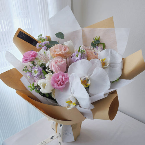 Phalaenopsis Orchid Bouquet with Roses and Matthiolas wrappined in Kraft Paper