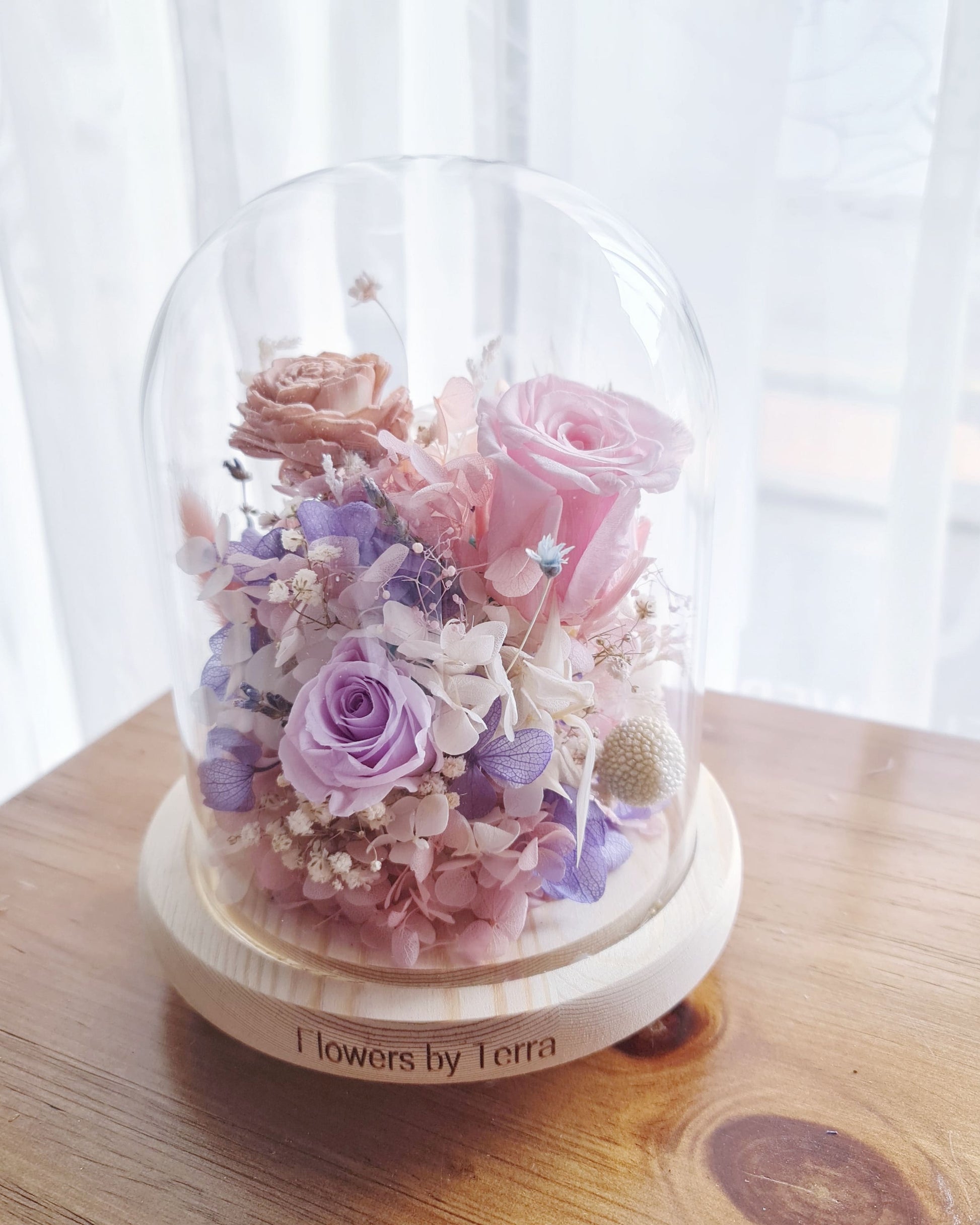 enchanté preserved flower dome with warm LED base light — Regular size with preserved roses, dried botanicals and sola wood flower by Flowers by Terra Singapore